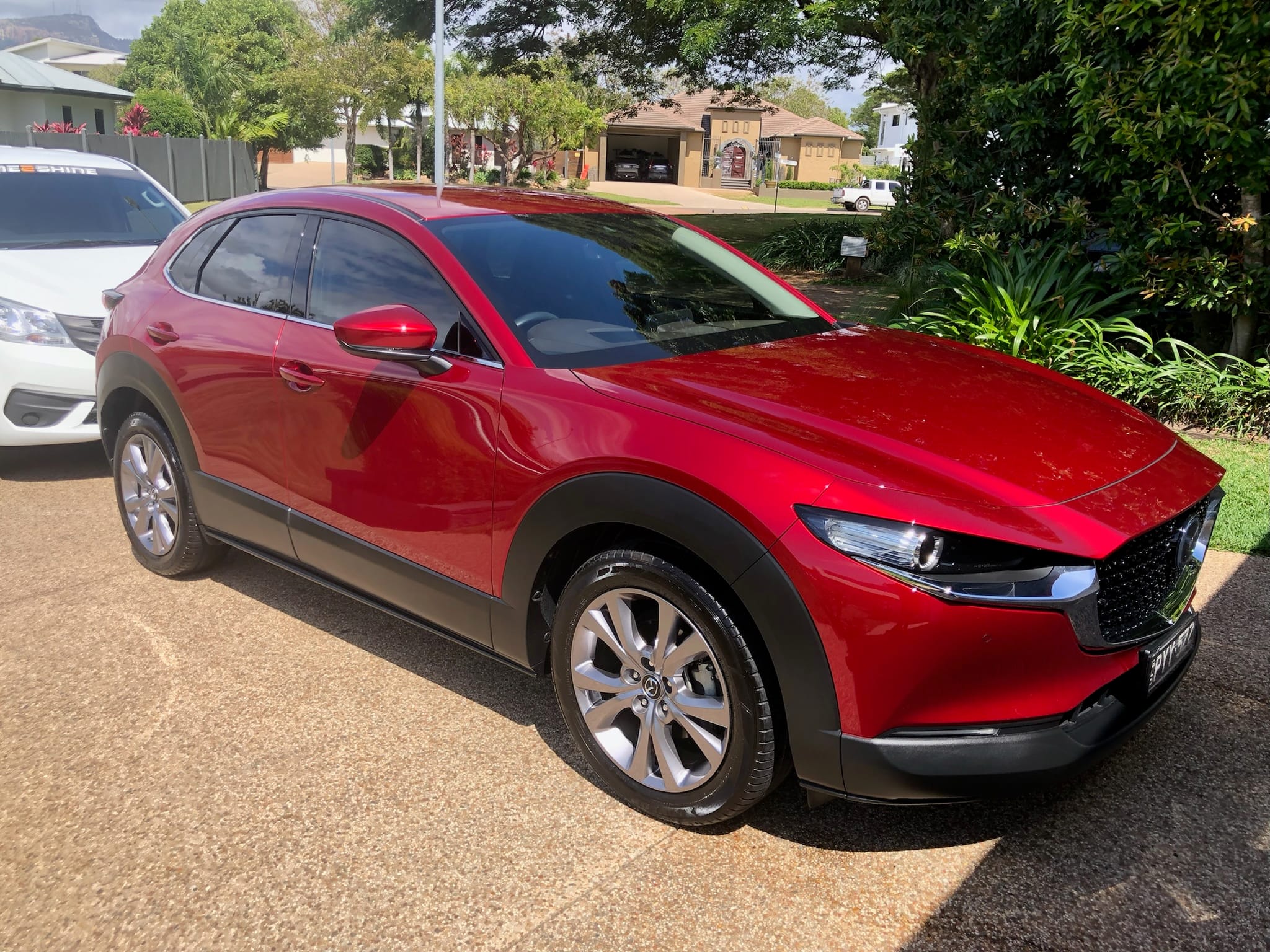 Red Mazda CX-30 freshly detailed in Victoria Point driveway
