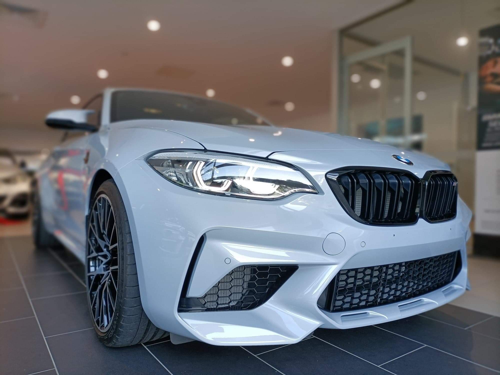BMW M2 Competition front angle after full detail in showroom