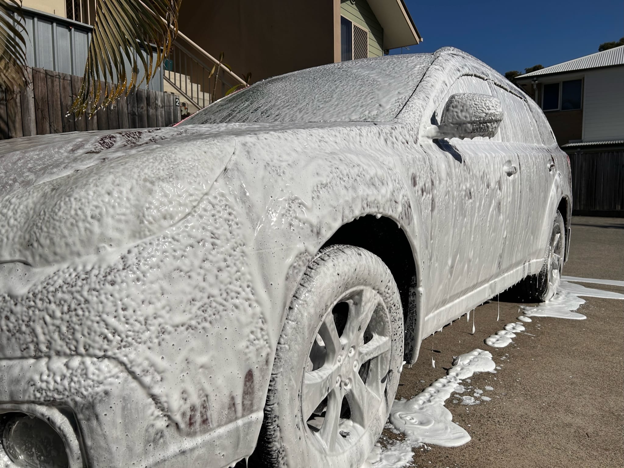 SUV covered in thick snow foam during mobile wash in Brisbane